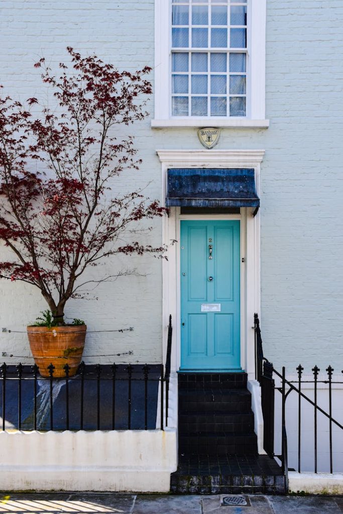 Elegant blue door with urban townhouse facade, showcasing traditional London charm.